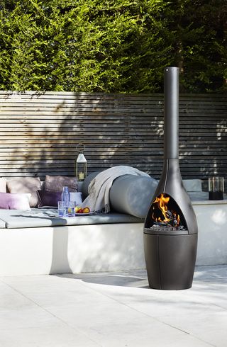 chiminea style fire pit on a patio