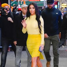 Kim Kardashian waves at the camera