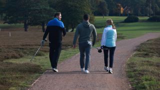 Three golfers walking on fairway