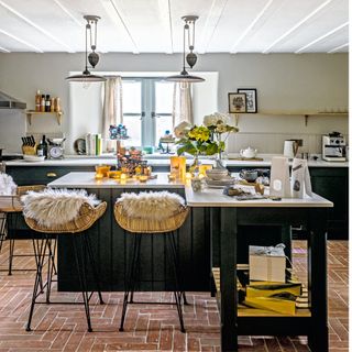 black island with beige stools, a white ceiling and light coloured walls