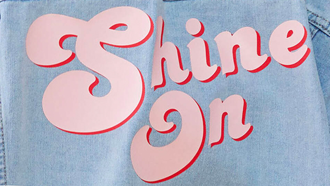 The slogan Shine On is on a denim jacket