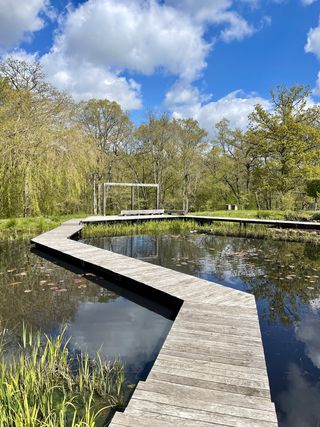 garden path ideas with a wood walkway on water