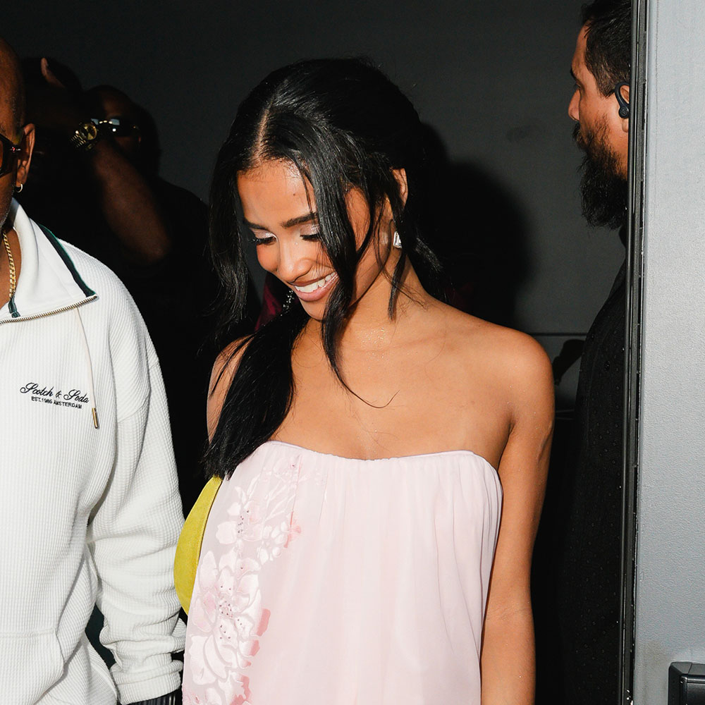 Tyla wearing a strapless babydoll dress and pink heels
