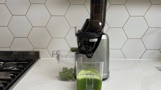 Kuvings B1700 being used to make green juice
