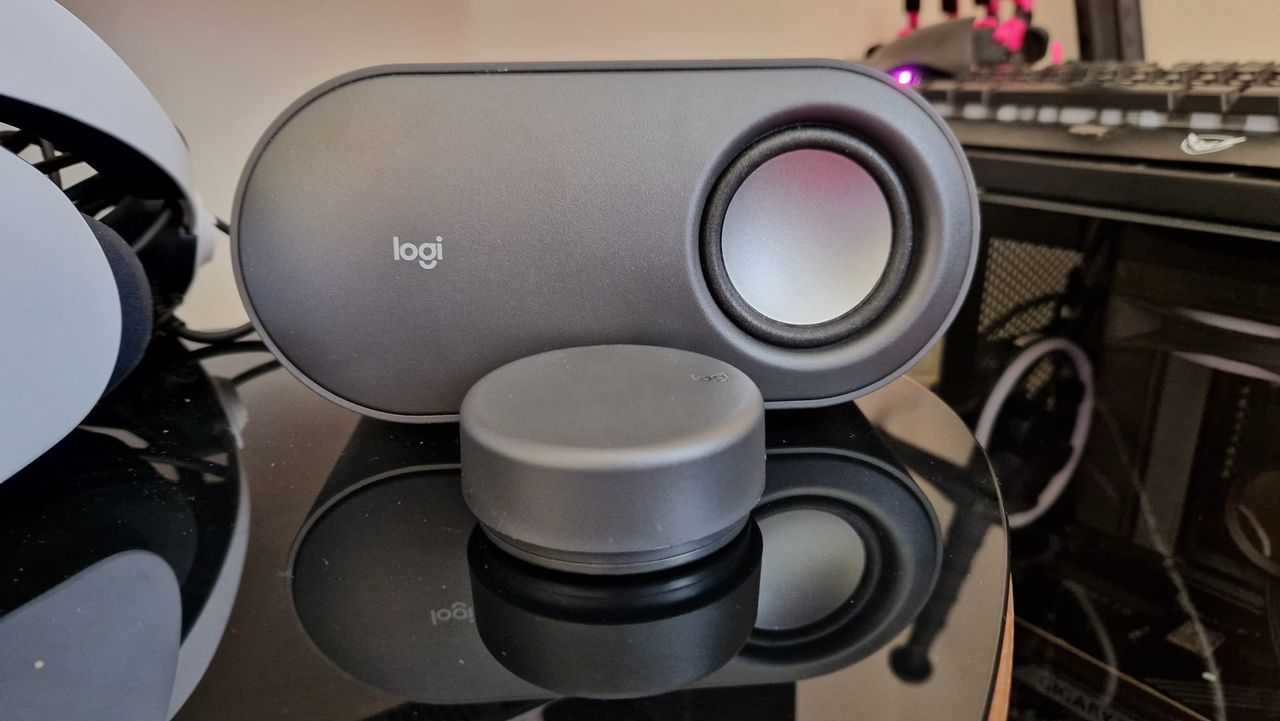 A Logitech Z407 review image showing the right satellite speaker with the control puck