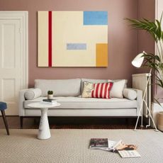 A quick delivery sofa in a modern living room with a large piece of contemporary art on the wall