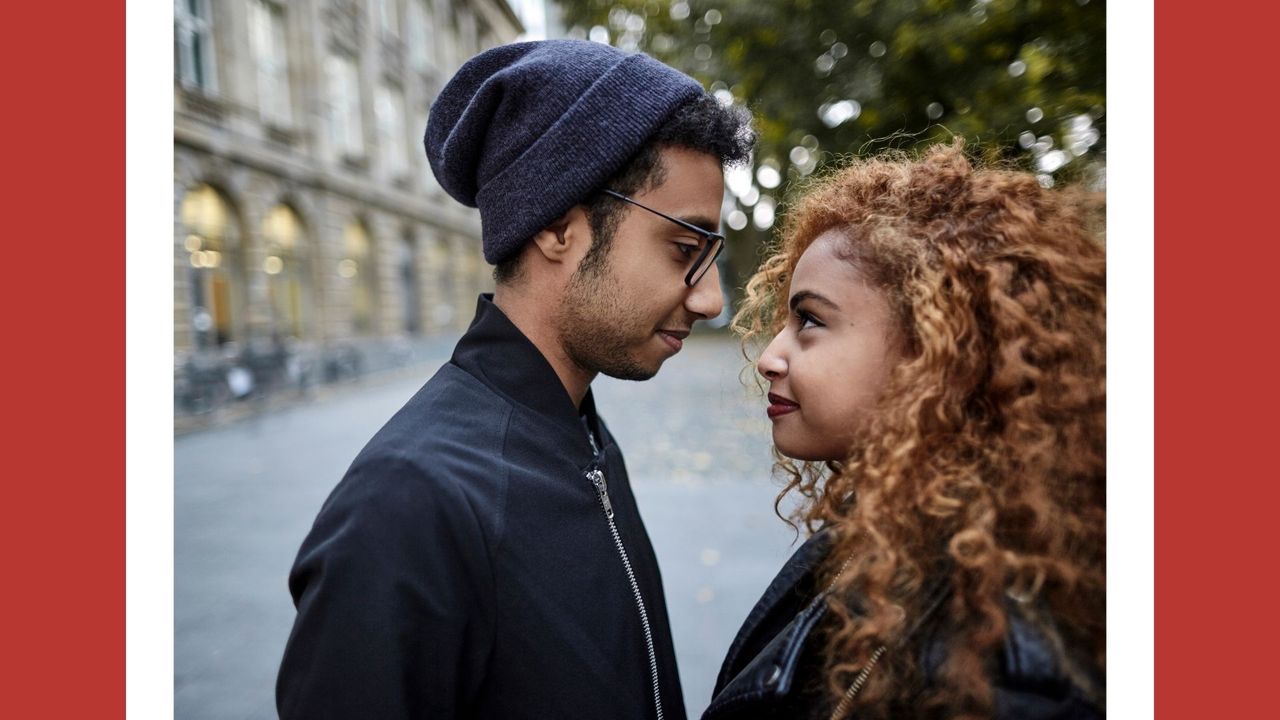 couple outside in the city staring at one another