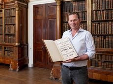 Charlie Courtenay, 19th Earl of Devon with his ancestor's book at Powderham Castle.