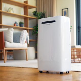 A white Pro Breeze dehumidifier in a room with a wooden floor