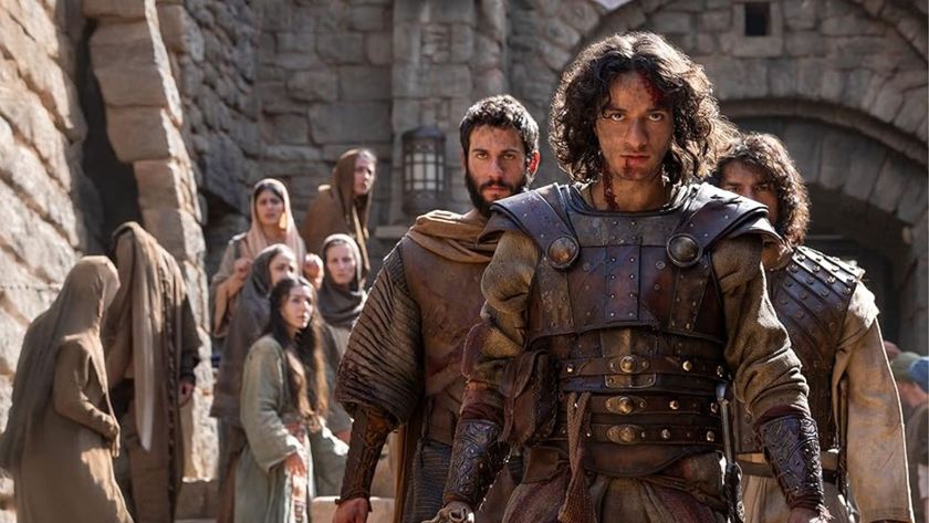 A group of soldiers descend a staircase while a group of villagers look on