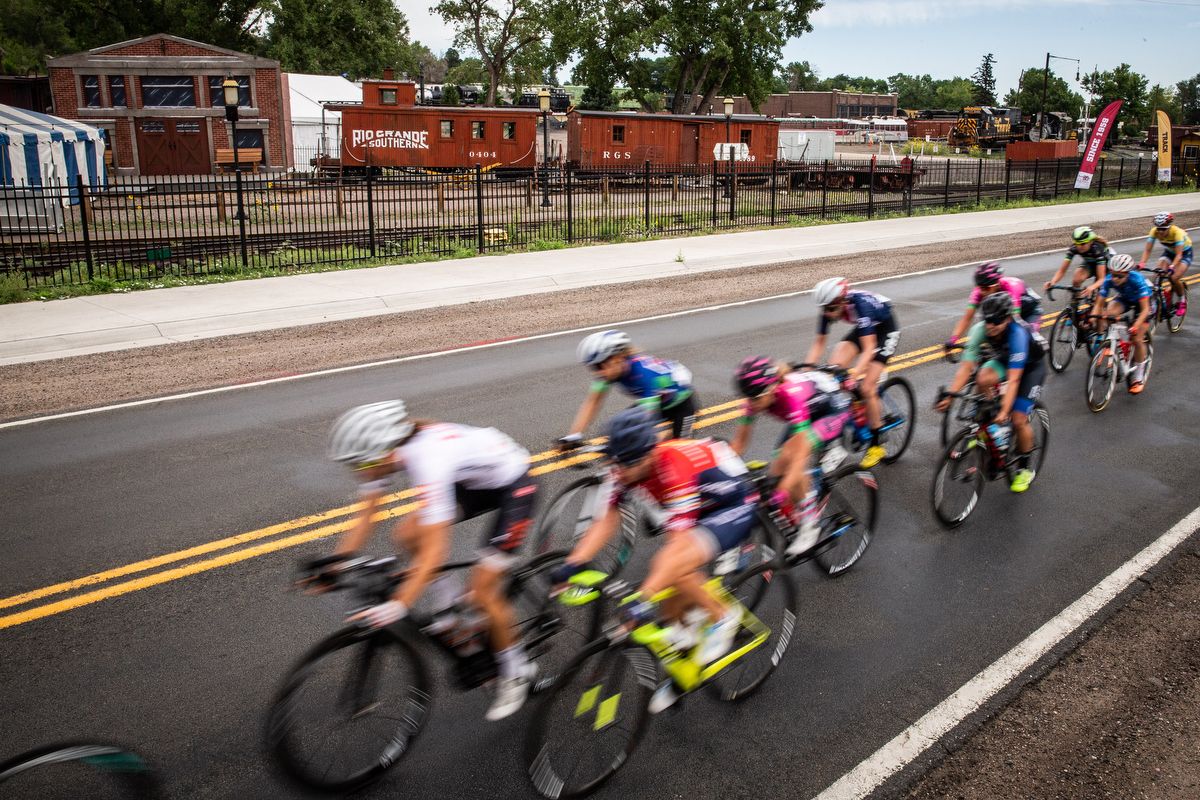 Riders pass by a train museum early on stage 3 of the Colorado Classic on August 24, 2019 in Golden, Colorado.