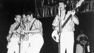 The Beach Boys perform onstage in 1964. (L-R) Al Jardine, Mike Love, Carl Wilson, Brian Wilson, and Dennis Wilson