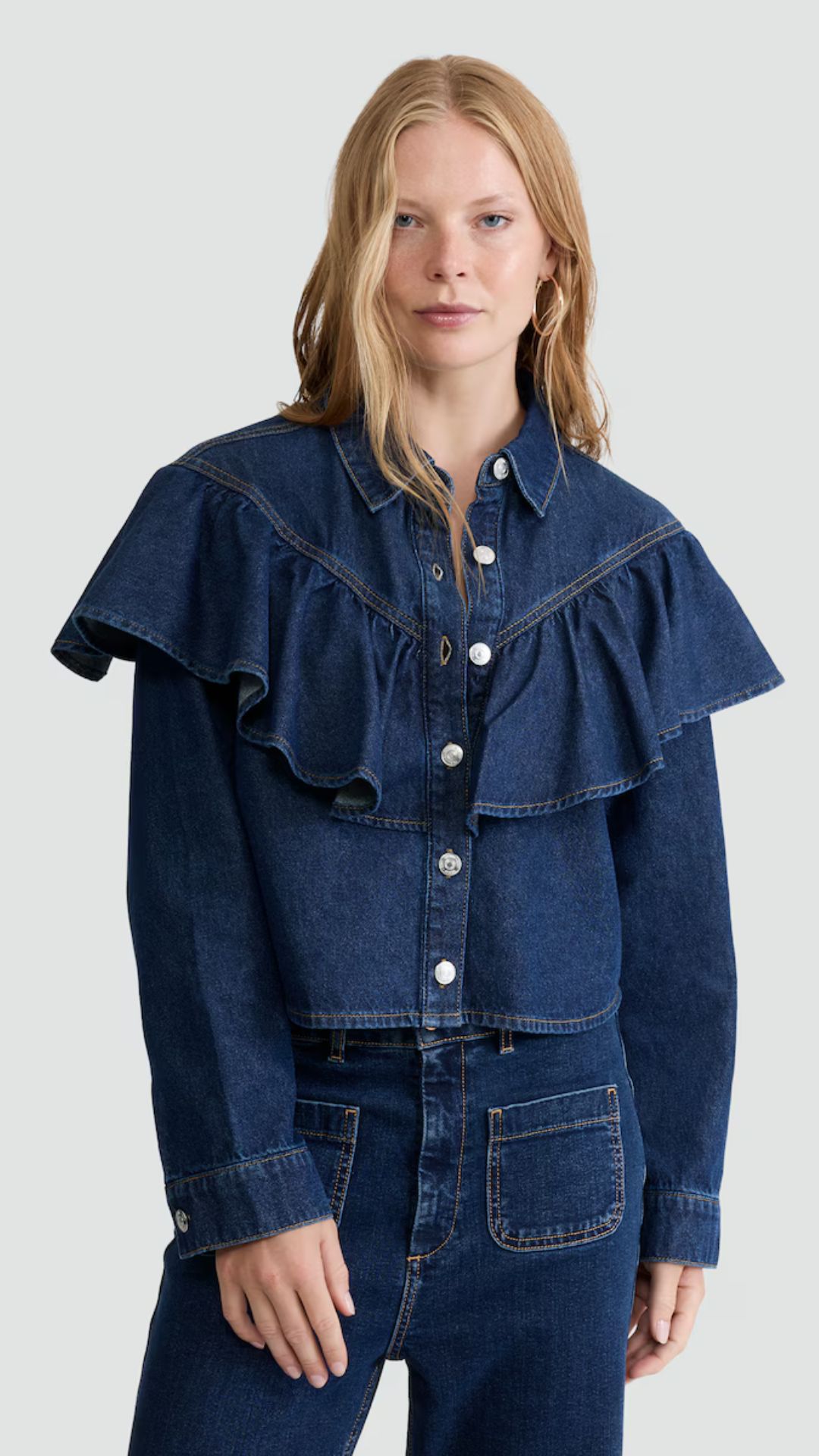 a model wearing the F&F denim ruffle shirt