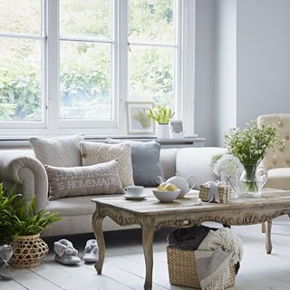 living room with white windows and sofaset with cushions
