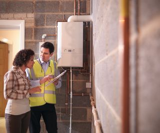 boiler installer explaining something to woman