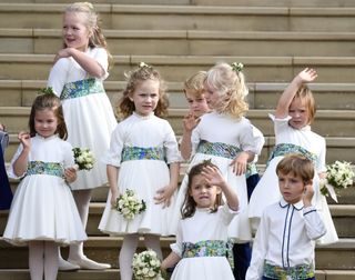 Princess Charlotte of Cambridge, Savannah Phillips, Maud Windsor, page boy Prince George of Cambridge, bridesmaids Isla Phillips, Theodora Williams, Mia Tindall and page boy Louis de Givenchy wave as they leave after the royal wedding of Princess Eugenie of York to Jack Brooksbank