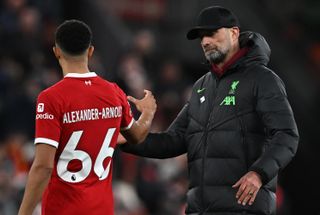 Liverpool's Trent Alexander-Arnold shakes the hand of manager Jurgen Klopp after a game against Manchester United in December 2023.