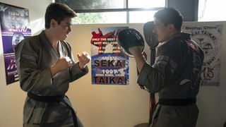 Patrick Luwis as Axel, Lewis Tan as Sensei Wolf in Cobra Kai