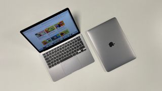 A top down view of two M1 MacBook Air laptops.