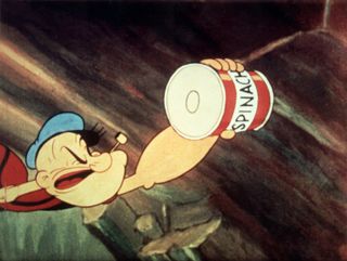 Popeye reaches for a can of spinach, which gives him super-strength 