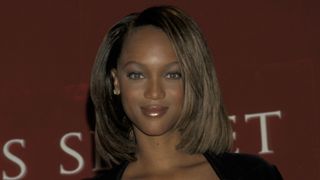 tyra banks in the 90s at an event with a layered bob haircut