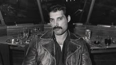 freddie mercury on a train in black and white