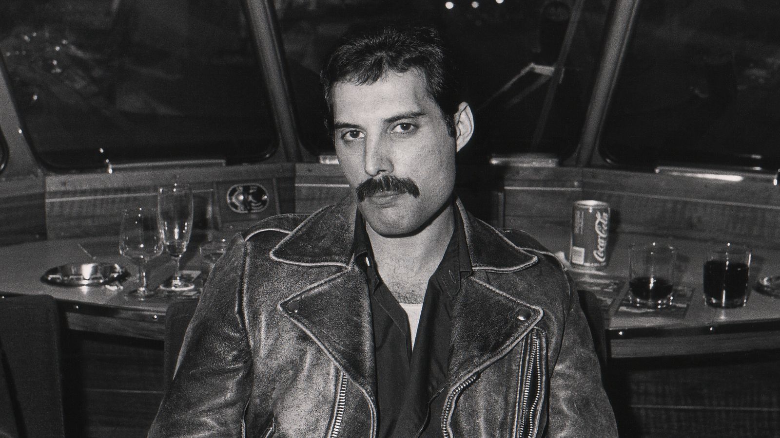 freddie mercury on a train in black and white