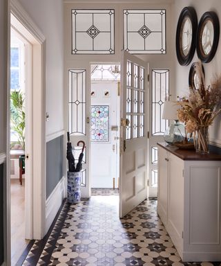 hallway with original floor tiles, stained glass and decorative cornicing