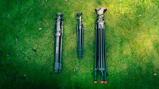 Sachtler and Manfrotto tripods on a grassy background