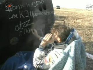 Russian cosmonaut Gennady Padalka, Expedition 32 commander, signs the Soyuz TMA-04M spacecraft used to land his three-man crew on the steppes of Kazakhstan on Sept. 16, 2012 EDT (Sept. 17 local time).