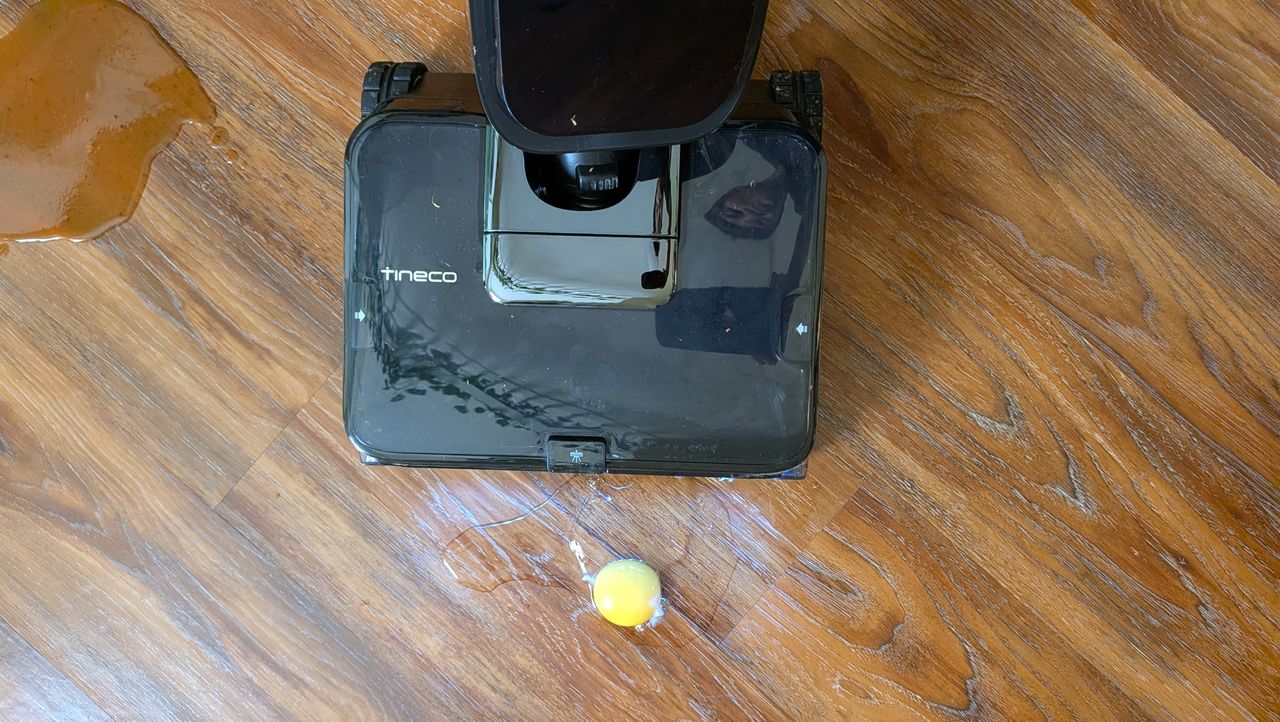 Tineco Floor ONE Station S9 Scientist Pro wet and dry vacuum cleaner about to clean egg off hard wood floor