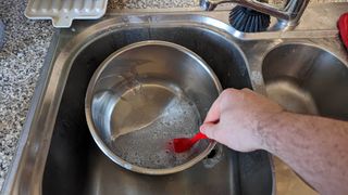 The pot of an Instant Pot being cleaned in the sink
