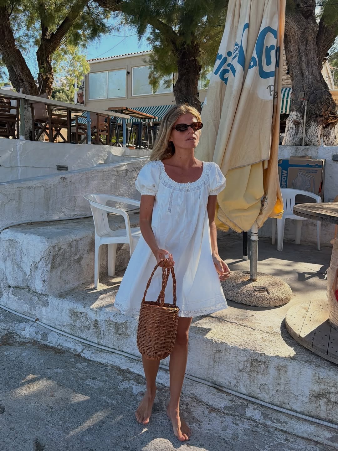 An image of @alicepilates wearing a white mini dress with cap sleeves from sustainable fashion brand Faithfull.