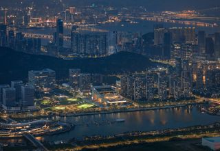 Night view of the Hengqin Culture and Art Complex with Macau in the distance