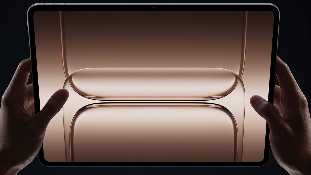OnePlus Pad 3 being held in hands with abstract image on screen