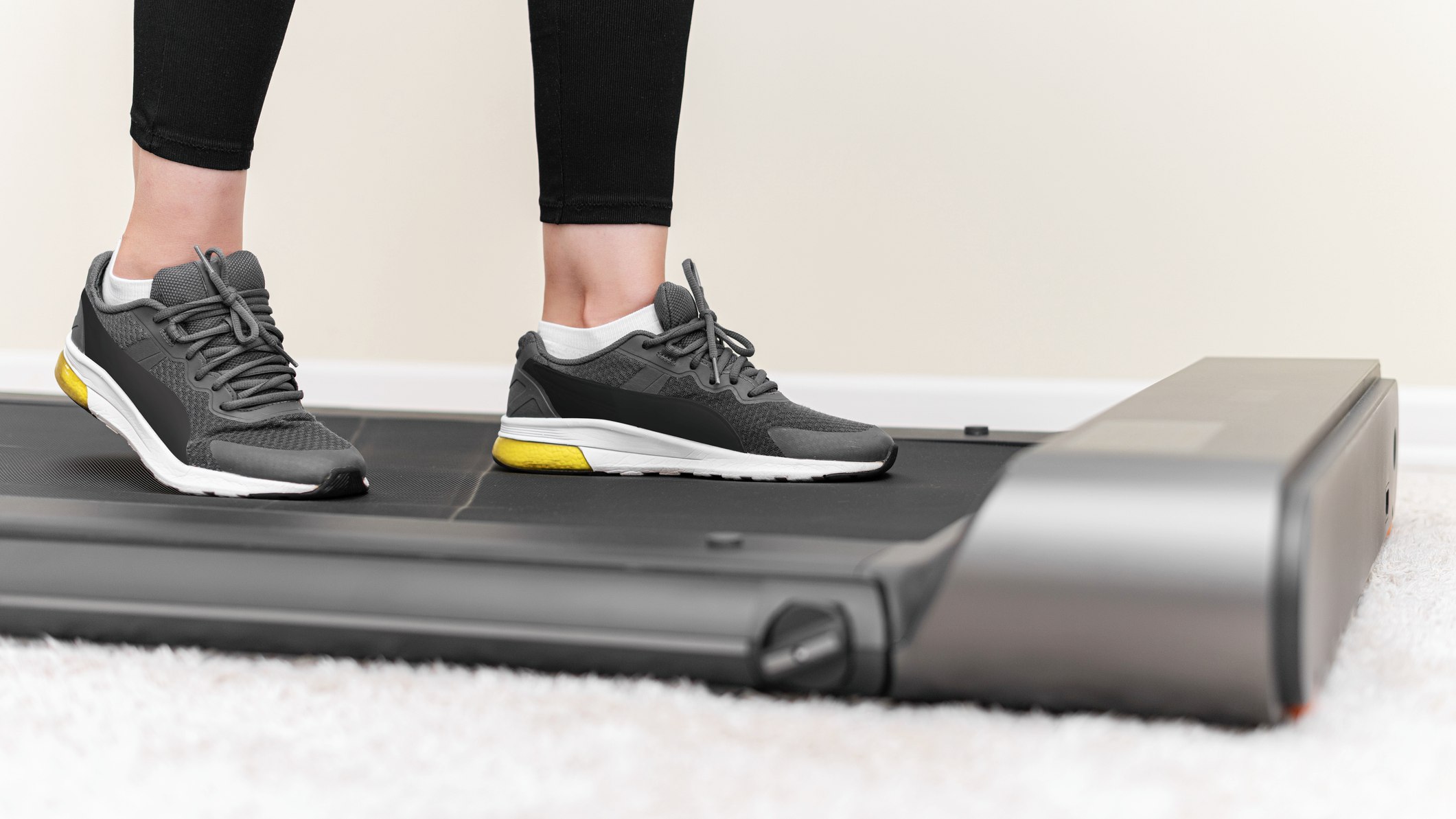 Caucasian person on walking pad from calves down