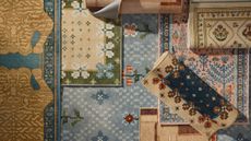 Assorted patterned rugs layered on top of one another from the new Anthropologie x Ruggable collaboration
