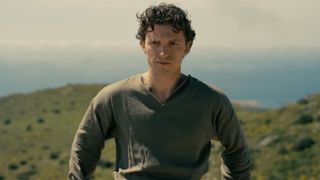Tom Holland standing in front of an incredible view of the ocean in The Odyssey