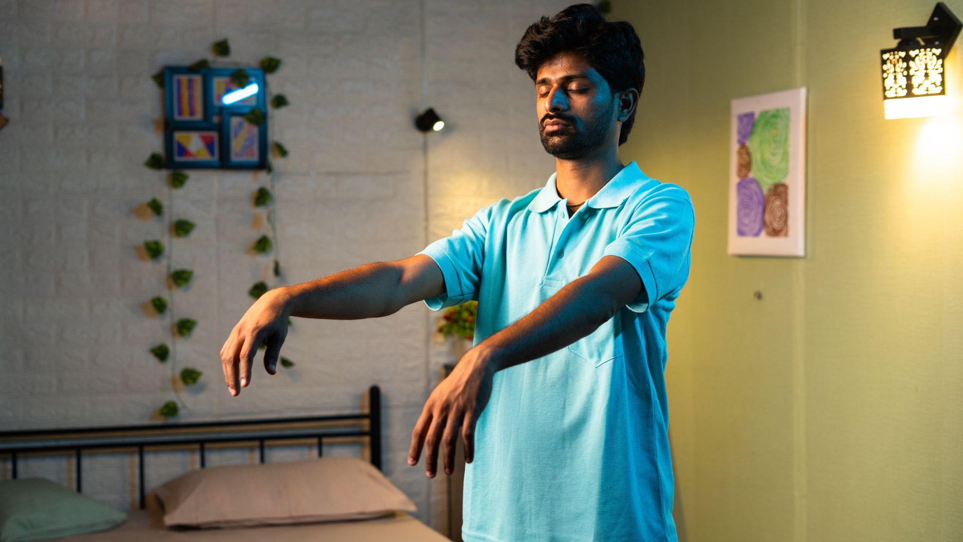 A man with his arms held out sleep walking in his bedroom
