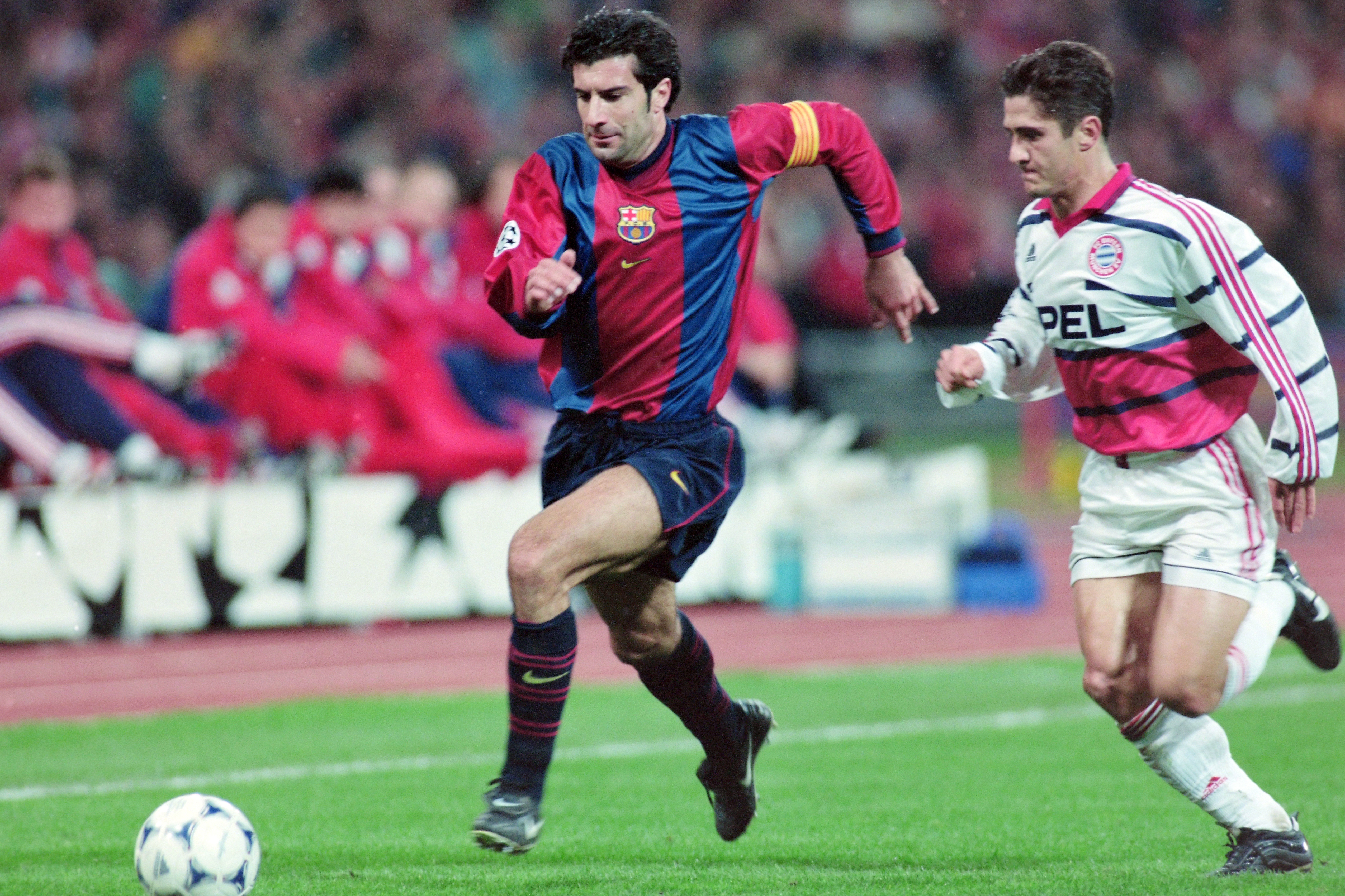 Barcelona's Luis Figo is tracked by Bayern Munich's Bixente Lizarazu in a Champions League game in 1998.