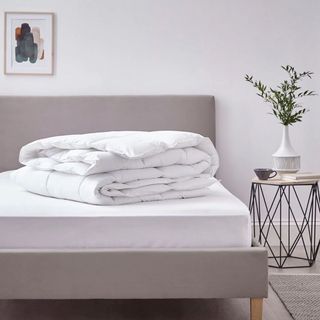 A duvet laid on an upholstered bed