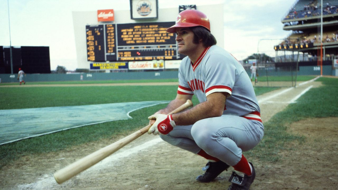 Cincinnati Reds player Pete Rose crouches on the field during a game against the New York Mets in 1978.