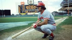 Cincinnati Reds player Pete Rose crouches on the field during a game against the New York Mets in 1978.