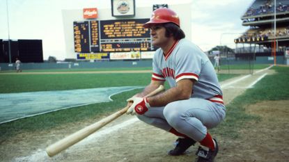 Cincinnati Reds player Pete Rose crouches on the field during a game against the New York Mets in 1978.