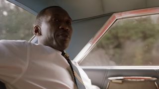 Mahershala Ali in a tie, sitting in a car in Green Book