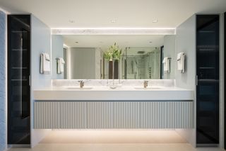 A bathroom with LED lights under the cabinet