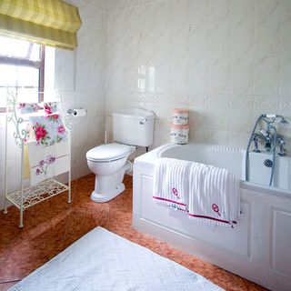 bathroom with tiles wall and bathtub
