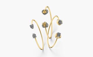 This is mixes yellow gold hardware with bees depicted in grey diamonds set with sterling silver.