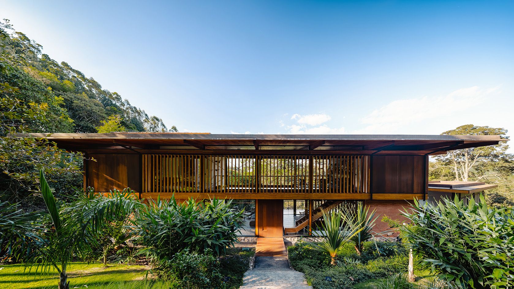 A holiday house in the woods of Brazil gives guests the impression of walking among trees