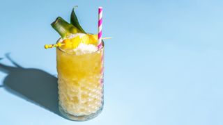 non-alcoholic Pina colada cocktail in glass with garnish and straw